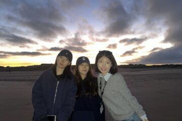 Charlotte, on the beach at St Andrews with two friends