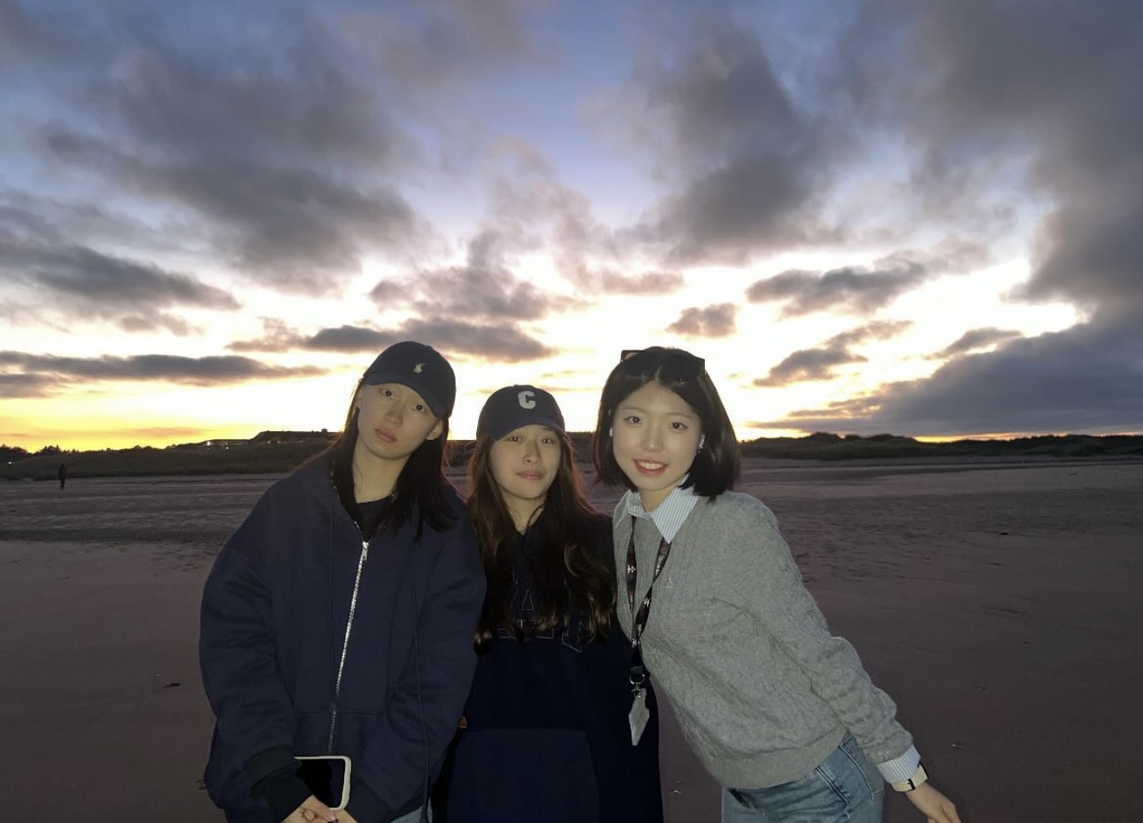 Charlotte, on the beach at St Andrews with two friends